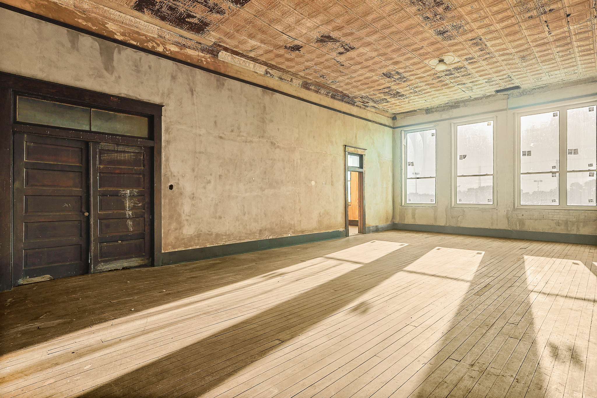 Second floor · Tin ceilings, tall windows, and wood floors